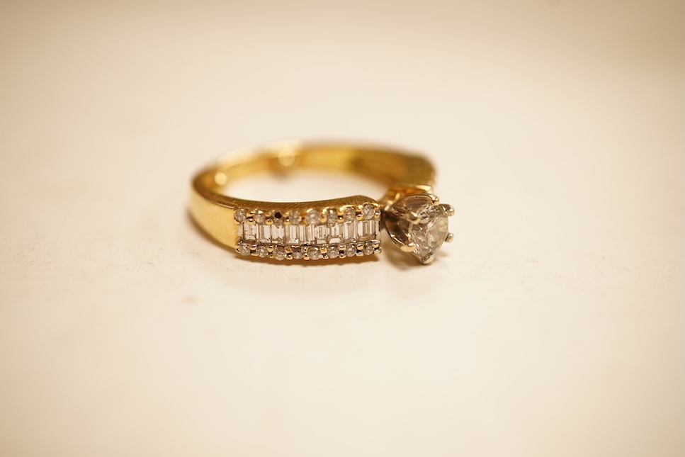 A modern yellow metal and single stone diamond set ring, with baguette and round cut diamond cluster set shoulders, total diamond weight approx. 0.50ct, size J/K (sizing spheres), gross weight 4.6 grams.